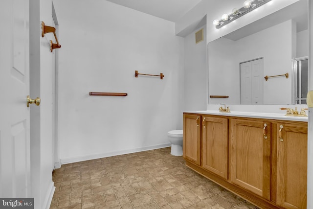 2495 Amber Orchard Ct E Unit 101, Odenton, MD 21113 - bathroom with double vanity, toilet, baseboards, and stone finish flooring