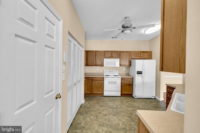 2495 Amber Orchard Ct E Unit 101, Odenton, MD 21113 - kitchen with white appliances, a ceiling fan, a sink, light countertops, and brown cabinetry