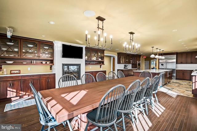2029 E Buckshutem Rd, Millville, NJ 08332 - dining space with a chandelier, wood-type flooring, recessed lighting, and a glass covered fireplace