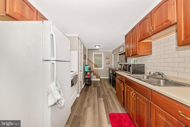 12535 Rockdale Rd, Clear Spring, MD 21722 - kitchen with white appliances, decorative backsplash, light countertops, wood finished floors, and crown molding