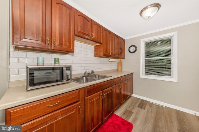 12535 Rockdale Rd, Clear Spring, MD 21722 - kitchen featuring stainless steel microwave, light wood-style floors, light countertops, backsplash, and ornamental molding