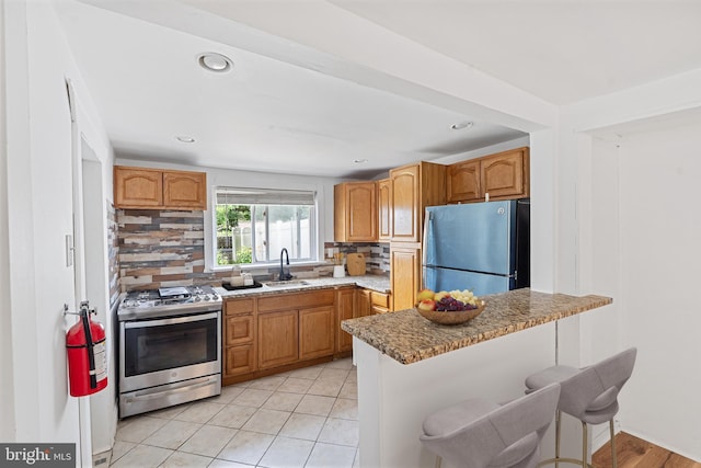 248 S Broadway, Gloucester City, NJ 08030 - kitchen with appliances with stainless steel finishes, backsplash, a kitchen bar, a peninsula, and recessed lighting