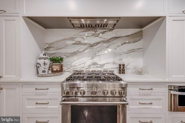 8 Rockland Vue Ct, Towson, MD 21204 - kitchen featuring high end stove, white cabinets, backsplash, and extractor fan