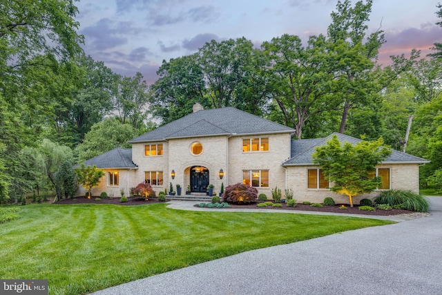 8 Rockland Vue Ct, Towson, MD 21204 - view of front of property featuring a front lawn, a chimney, brick siding, a shingled roof, and view of scattered trees