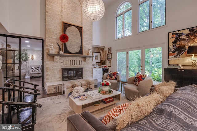 8 Rockland Vue Ct, Towson, MD 21204 - living room featuring a high ceiling, healthy amount of natural light, a fireplace, and wood finished floors