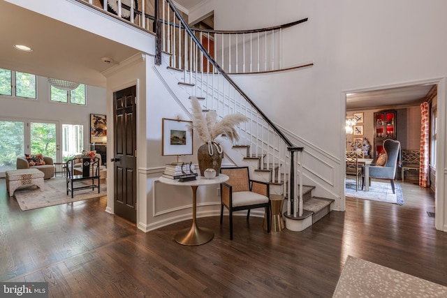 8 Rockland Vue Ct, Towson, MD 21204 - staircase with a towering ceiling, wood finished floors, a decorative wall, a wainscoted wall, and crown molding