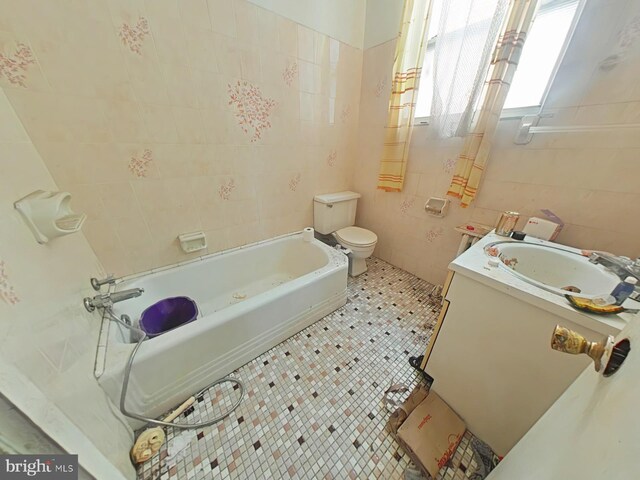 1620 S Broad St, Philadelphia, PA 19145 - bathroom with vanity, a bathtub, tile walls, and tile patterned floors