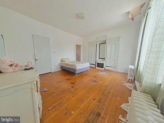 1620 S Broad St, Philadelphia, PA 19145 - bedroom with radiator heating unit, light wood-style floors, and a baseboard heating unit