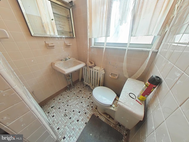 1620 S Broad St, Philadelphia, PA 19145 - half bathroom featuring tile walls, radiator heating unit, and tile patterned flooring