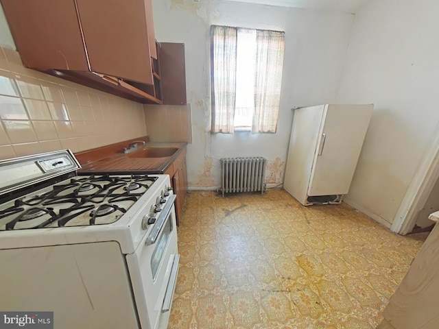 1620 S Broad St, Philadelphia, PA 19145 - kitchen featuring white appliances, radiator heating unit, and backsplash