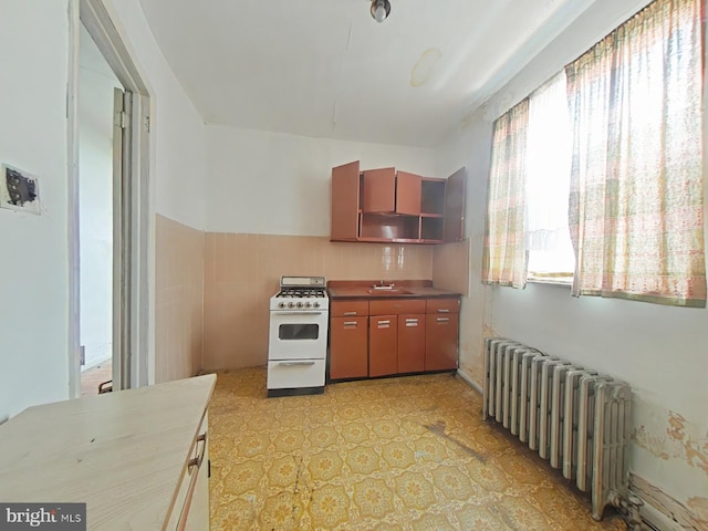 1620 S Broad St, Philadelphia, PA 19145 - kitchen featuring radiator heating unit, gas range gas stove, light flooring, and open shelves