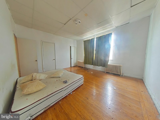 1620 S Broad St, Philadelphia, PA 19145 - bedroom with radiator heating unit, a drop ceiling, and hardwood / wood-style floors