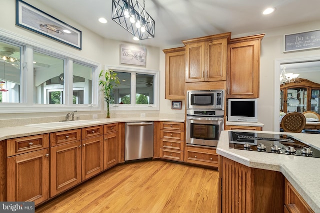 3950 Island Crk, Broomes Island, MD 20615 - kitchen with stainless steel appliances, light countertops, brown cabinetry, a chandelier, and recessed lighting