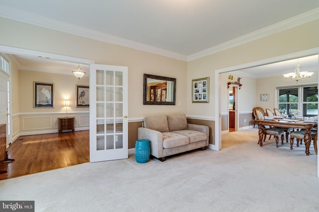 3950 Island Crk, Broomes Island, MD 20615 - carpeted living area featuring ornamental molding, a chandelier, and french doors