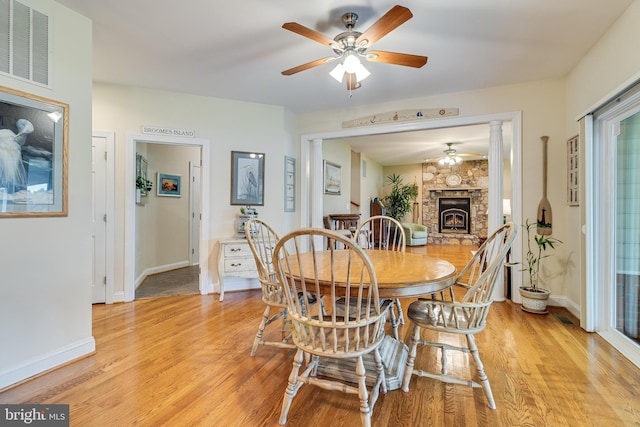 3950 Island Crk, Broomes Island, MD 20615 - dining room featuring ceiling fan, light wood-type flooring, and a stone fireplace