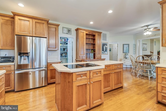3950 Island Crk, Broomes Island, MD 20615 - kitchen featuring stainless steel fridge, black electric cooktop, a center island, open shelves, and light countertops