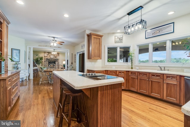 3950 Island Crk, Broomes Island, MD 20615 - kitchen with black electric cooktop, light wood-style flooring, brown cabinetry, a breakfast bar, and recessed lighting