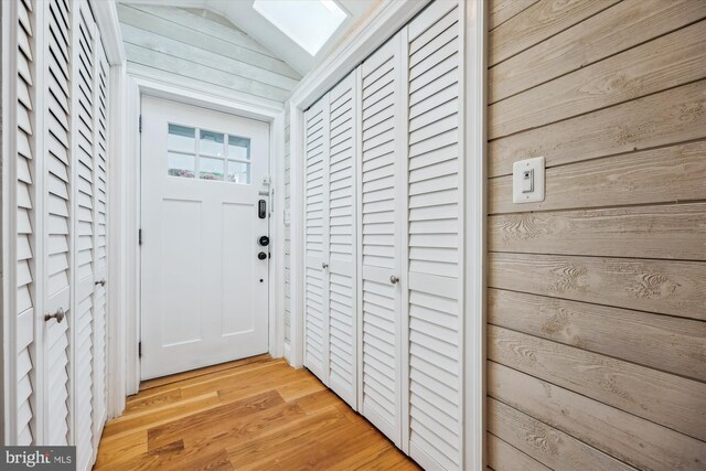 11218 Monticello Ave, Silver Spring, MD 20902 - doorway to outside featuring wood walls and light wood finished floors