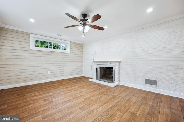 11218 Monticello Ave, Silver Spring, MD 20902 - unfurnished living room featuring a fireplace with raised hearth, ceiling fan, light wood-style flooring, crown molding, and recessed lighting