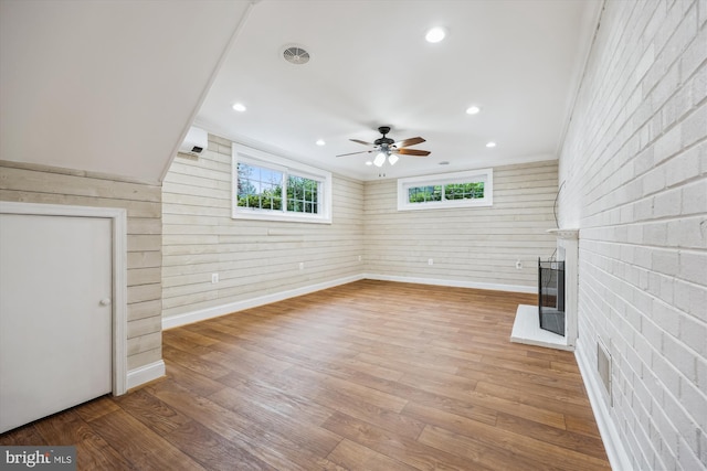 11218 Monticello Ave, Silver Spring, MD 20902 - unfurnished living room with a glass covered fireplace, wood finished floors, an AC wall unit, ceiling fan, and recessed lighting
