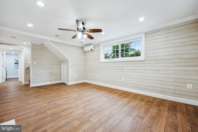 11218 Monticello Ave, Silver Spring, MD 20902 - unfurnished living room with wood walls, light wood-style flooring, an AC wall unit, a ceiling fan, and stairway