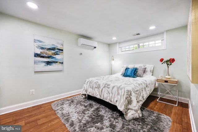 11218 Monticello Ave, Silver Spring, MD 20902 - bedroom featuring a wall unit AC, wood finished floors, and recessed lighting