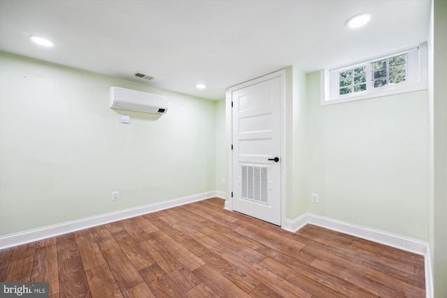 11218 Monticello Ave, Silver Spring, MD 20902 - below grade area with a wall mounted air conditioner, wood finished floors, and recessed lighting