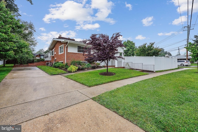 11218 Monticello Ave, Silver Spring, MD 20902 - view of front of home featuring brick siding, a chimney, and concrete driveway