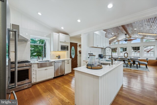 11218 Monticello Ave, Silver Spring, MD 20902 - kitchen with appliances with stainless steel finishes, backsplash, light wood finished floors, crown molding, and a ceiling fan