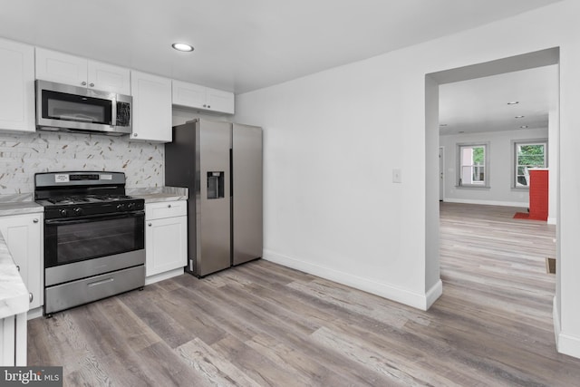 218 Sewell Ave, Hamilton, NJ 08610 - kitchen with appliances with stainless steel finishes, light countertops, white cabinets, light wood finished floors, and recessed lighting