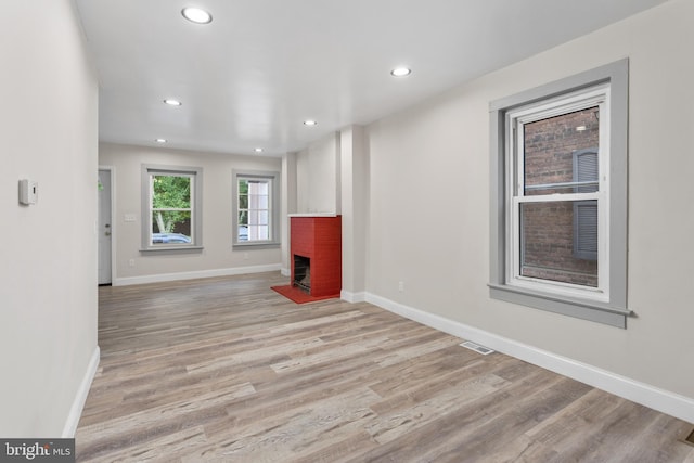218 Sewell Ave, Hamilton, NJ 08610 - unfurnished living room featuring a brick fireplace, light wood-type flooring, recessed lighting, and baseboards