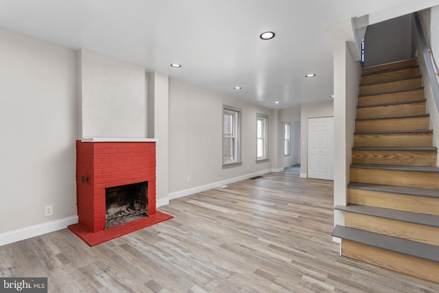 218 Sewell Ave, Hamilton, NJ 08610 - unfurnished living room with stairway, baseboards, light wood-type flooring, a brick fireplace, and recessed lighting