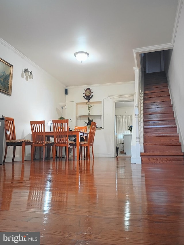 916 S Carey St, Baltimore, MD 21223 - dining area featuring ornamental molding, stairway, and wood-type flooring