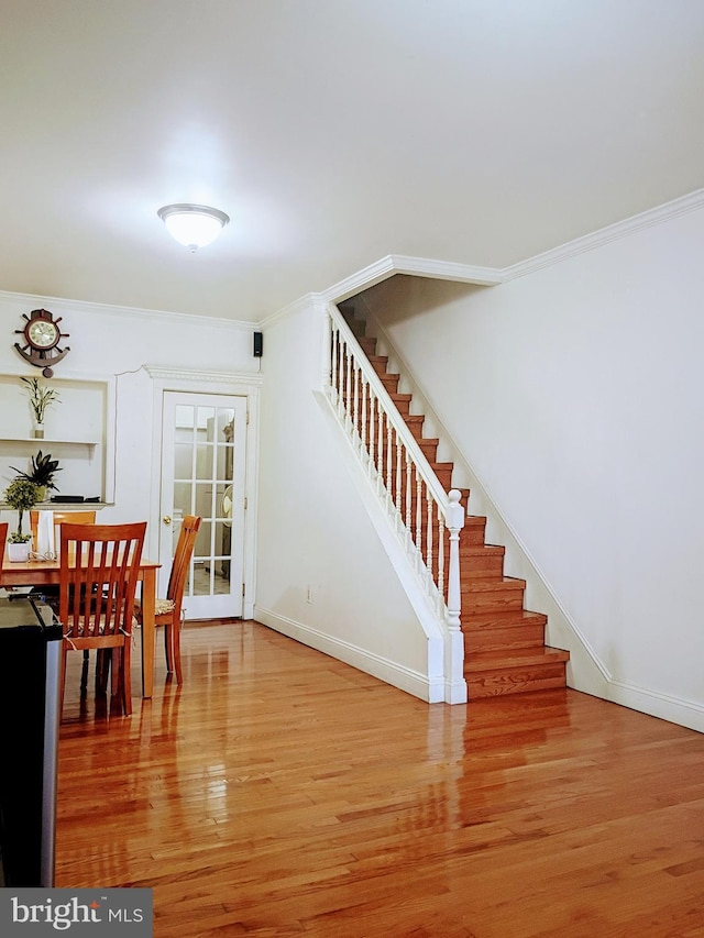 916 S Carey St, Baltimore, MD 21223 - dining room with stairs, wood finished floors, and crown molding