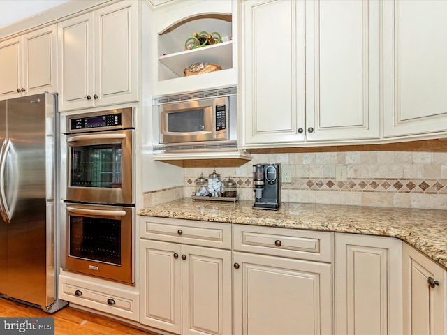 22324 Canterfield Way, Germantown, MD 20876 - kitchen featuring stainless steel appliances, tasteful backsplash, light stone countertops, and light wood-style flooring