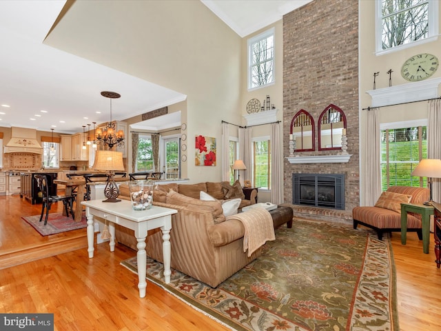 22324 Canterfield Way, Germantown, MD 20876 - living room with a towering ceiling, healthy amount of natural light, a brick fireplace, and light wood finished floors
