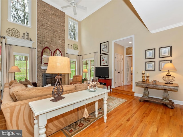 22324 Canterfield Way, Germantown, MD 20876 - living area with a towering ceiling, light wood-style flooring, healthy amount of natural light, a ceiling fan, and baseboards