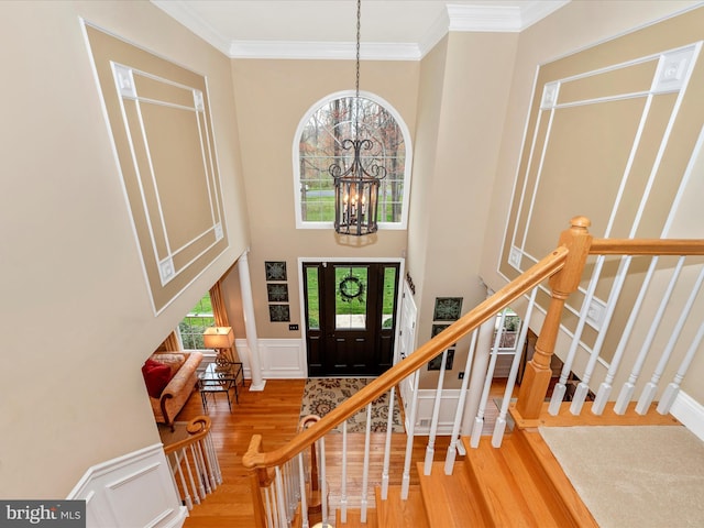 22324 Canterfield Way, Germantown, MD 20876 - entrance foyer featuring healthy amount of natural light, wood finished floors, a chandelier, ornamental molding, and a high ceiling