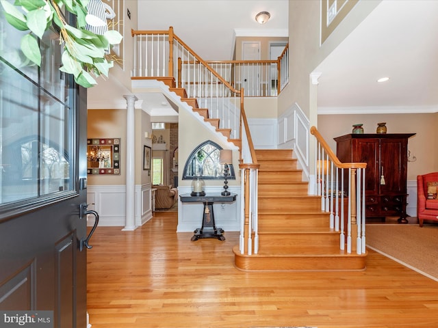22324 Canterfield Way, Germantown, MD 20876 - foyer entrance with light wood finished floors, a towering ceiling, a decorative wall, stairs, and ornamental molding