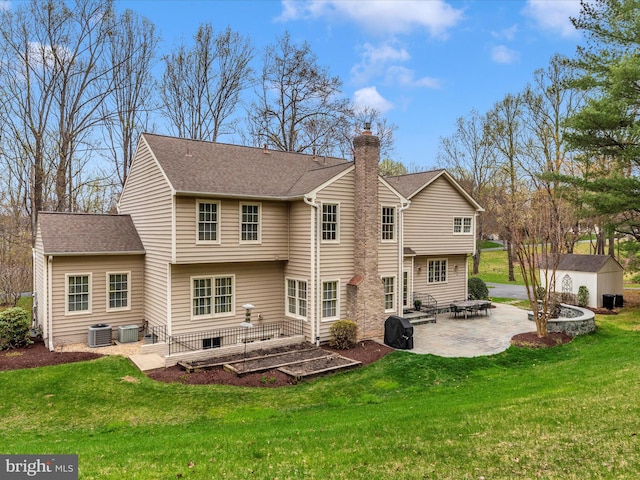 22324 Canterfield Way, Germantown, MD 20876 - rear view of property with a patio, a yard, a chimney, central air condition unit, and roof with shingles