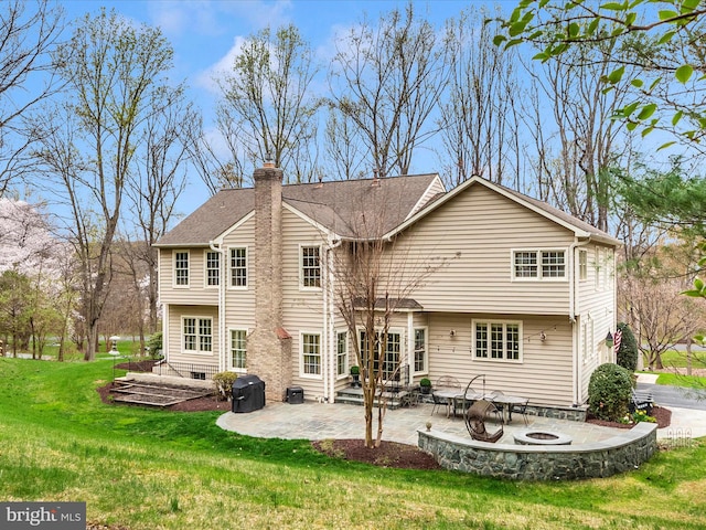 22324 Canterfield Way, Germantown, MD 20876 - rear view of property featuring a patio area, an outdoor fire pit, a yard, and a chimney
