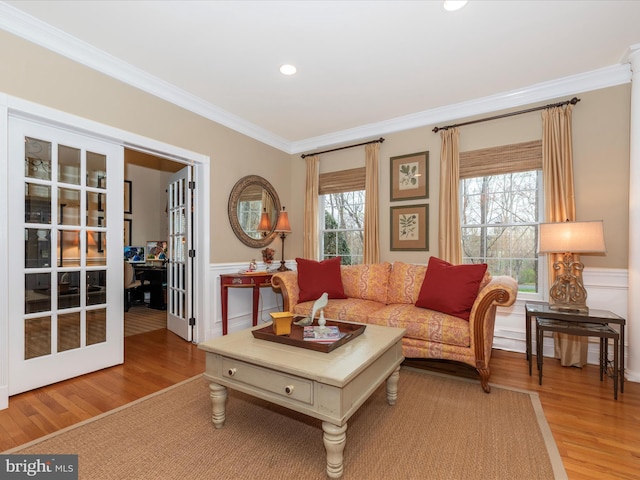 22324 Canterfield Way, Germantown, MD 20876 - living room featuring crown molding, light wood-style floors, french doors, a wainscoted wall, and recessed lighting