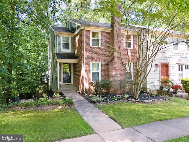 5730 Walnut Wood Ln, Burke, VA 22015 - traditional-style house featuring a front lawn, a chimney, and brick siding