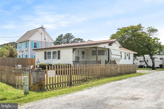 8096 Mire Pond One, Chincoteague Island, VA 23336 - view of front facade featuring a fenced front yard and driveway