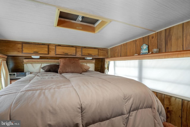8096 Mire Pond One, Chincoteague Island, VA 23336 - bedroom featuring wood walls