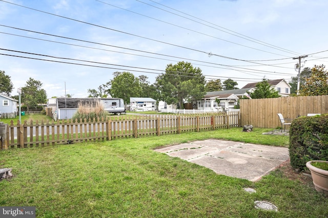 8096 Mire Pond One, Chincoteague Island, VA 23336 - fenced backyard with a patio and a residential view