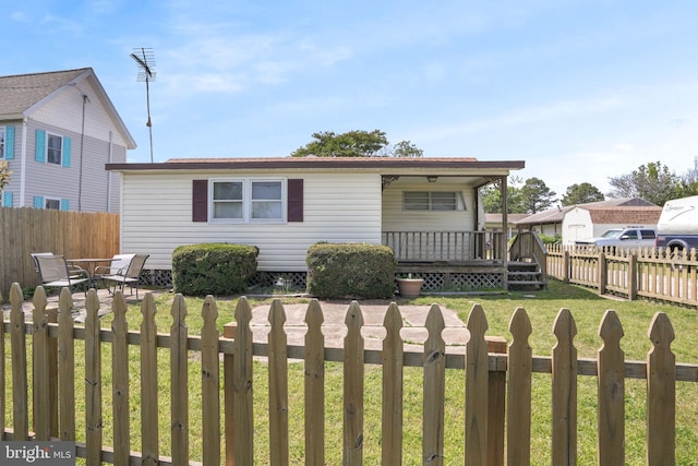 8096 Mire Pond One, Chincoteague Island, VA 23336 - view of front facade with a fenced backyard and a wooden deck