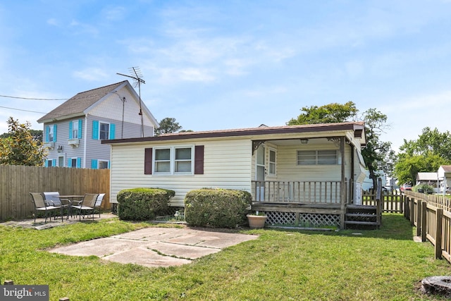 8096 Mire Pond One, Chincoteague Island, VA 23336 - back of house featuring a fenced backyard, a porch, and a patio