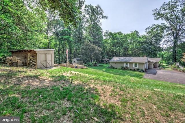 1534 Benton Hollow Rd, Drumore, PA 17518 - view of green lawn with an outbuilding, asphalt driveway, and a carport