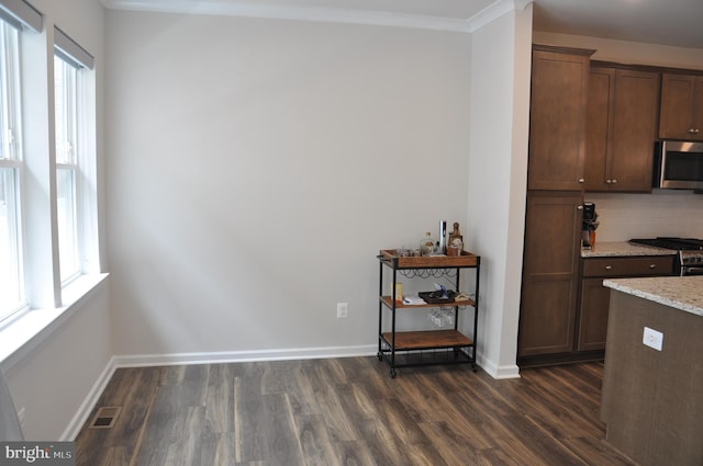 16150 Bowery St, Rockville, MD 20855 - kitchen featuring appliances with stainless steel finishes, dark wood-style flooring, light stone countertops, tasteful backsplash, and baseboards